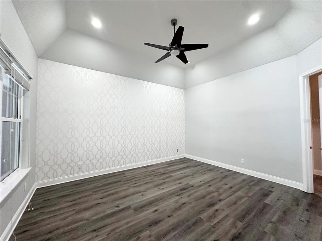 9319 Richet Place Orlando, FL 32827 - Photo 21 of 50 a view of a big room with wooden floor closet and windows