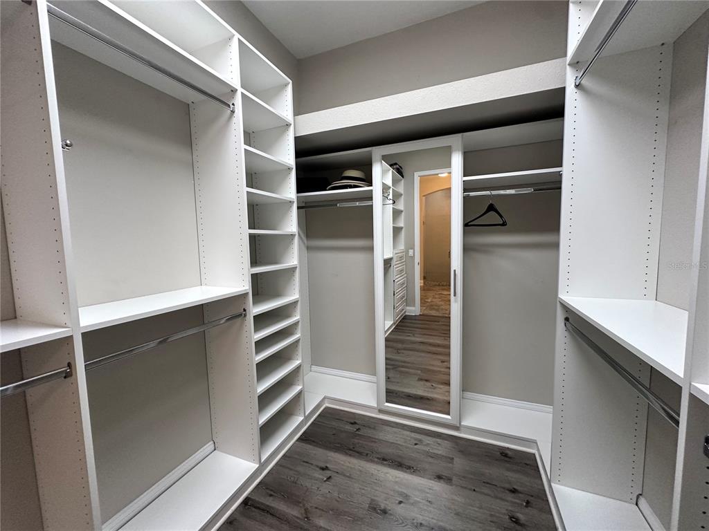 9319 Richet Place Orlando, FL 32827 - Photo 23 of 50 a view of walk in closet with empty racks