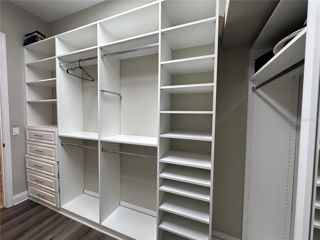 9319 Richet Place Orlando, FL 32827 - Photo 24 of 50 a view of walk in closet with empty racks