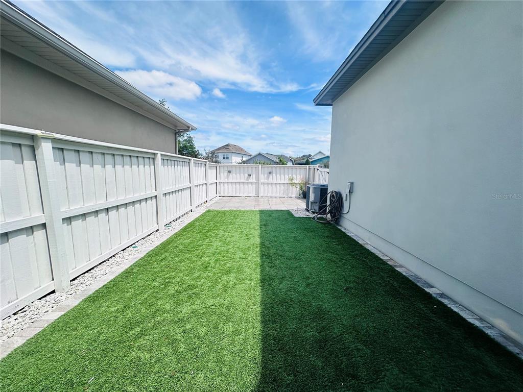 9319 Richet Place Orlando, FL 32827 - Photo 28 of 50 a view of a backyard with a garden