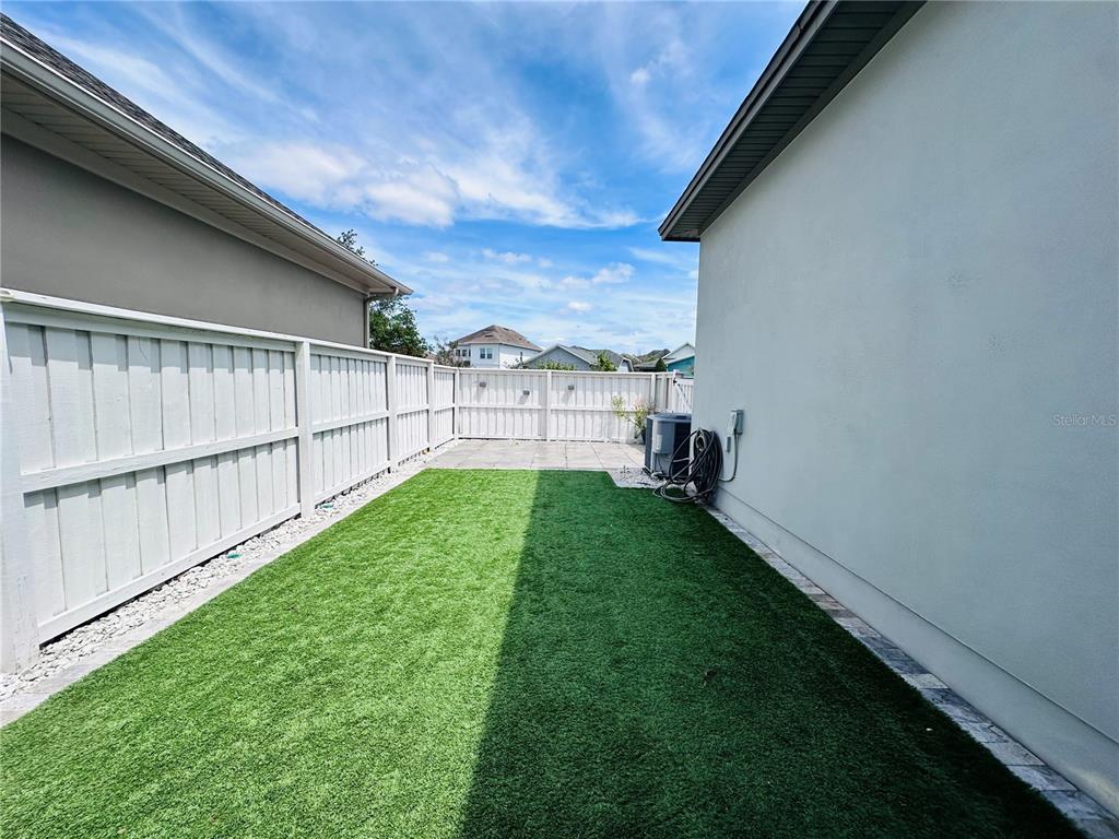 9319 Richet Place Orlando, FL 32827 - Photo 32 of 50 a view of a backyard with garden