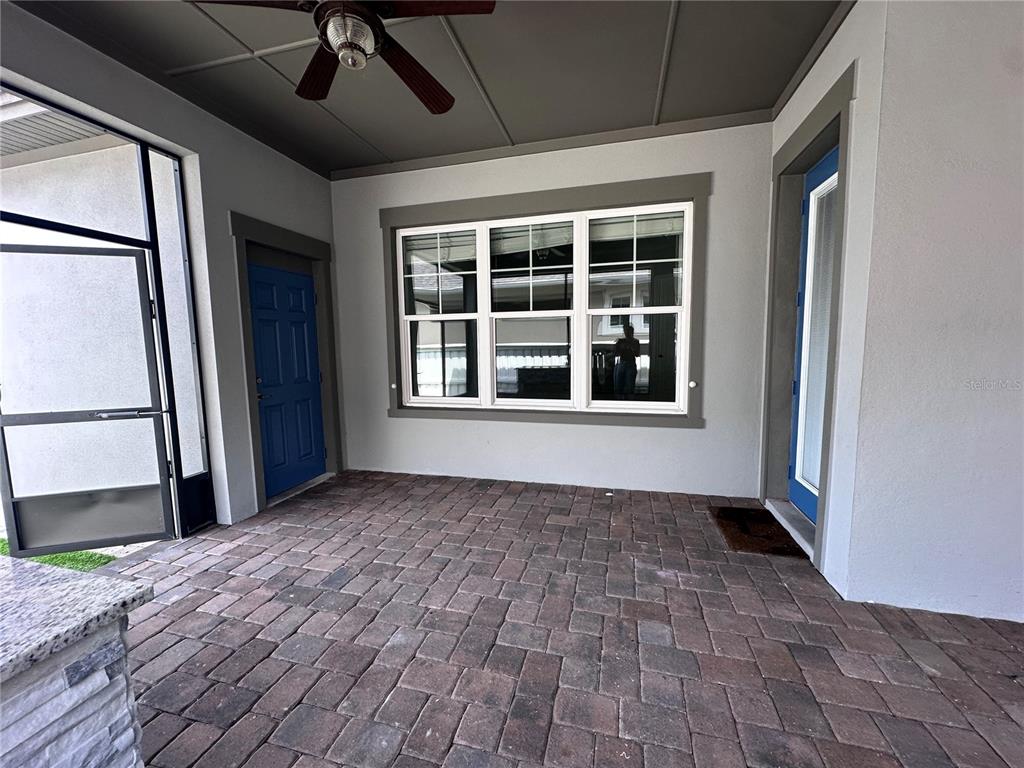 9319 Richet Place Orlando, FL 32827 - Photo 35 of 50 a view of an empty room with a window and a kitchen