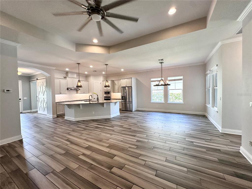 9319 Richet Place Orlando, FL 32827 - Photo 4 of 50 a view of an empty room with window and wooden floor