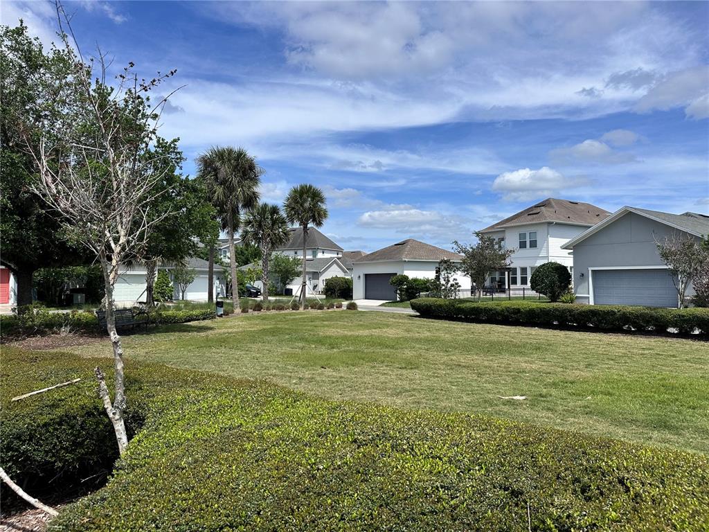 9319 Richet Place Orlando, FL 32827 - Photo 44 of 50 a front view of house with yard and green space