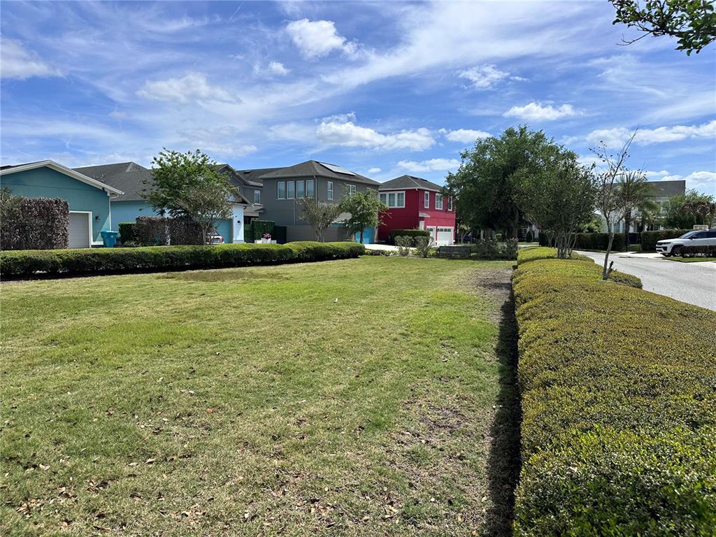 9319 Richet Place Orlando, FL 32827 - Photo 48 of 50 a front view of house with yard and trees in the background