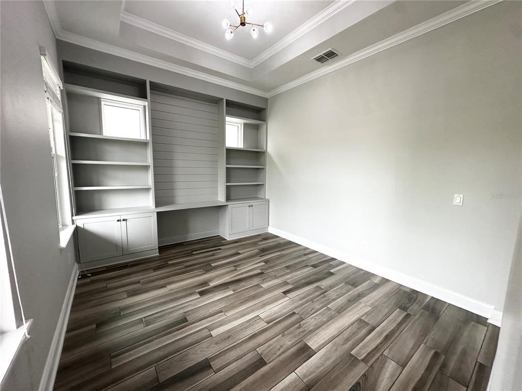 9319 Richet Place Orlando, FL 32827 - Photo 5 of 50 a view of empty room with wooden floor and fan