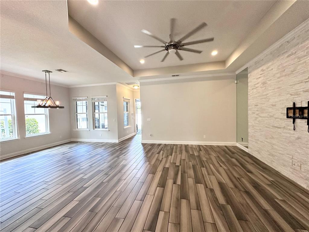 9319 Richet Place Orlando, FL 32827 - Photo 8 of 50 a view of an empty room with wooden floor and a window