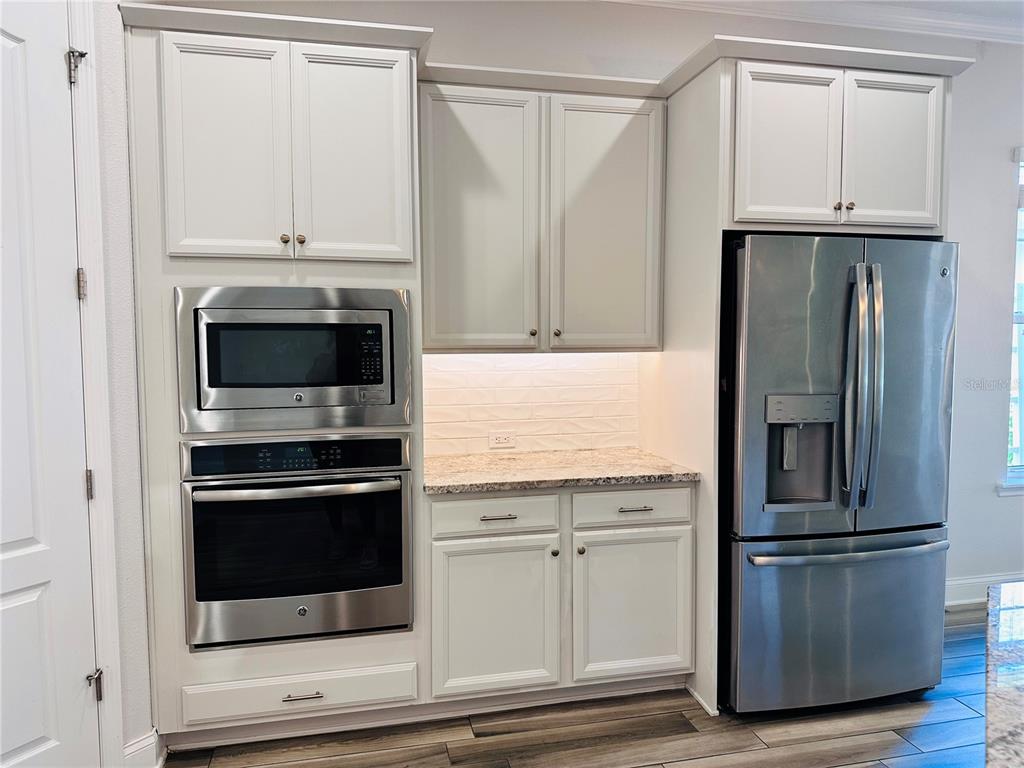 9319 Richet Place Orlando, FL 32827 - Photo 10 of 50 a kitchen with cabinets and stainless steel appliances