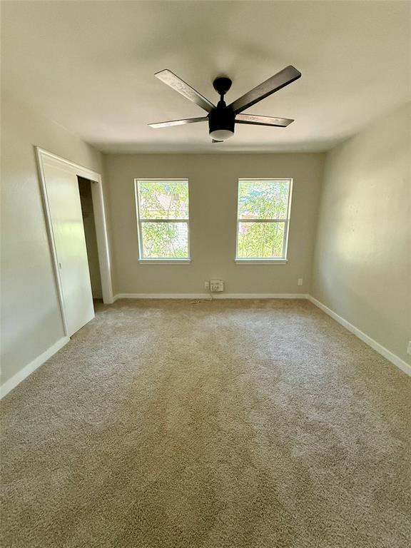 4815 Kelman Street Dallas, TX 75214 - Photo 11 of 16 Empty room featuring light colored carpet and a ceiling fan
