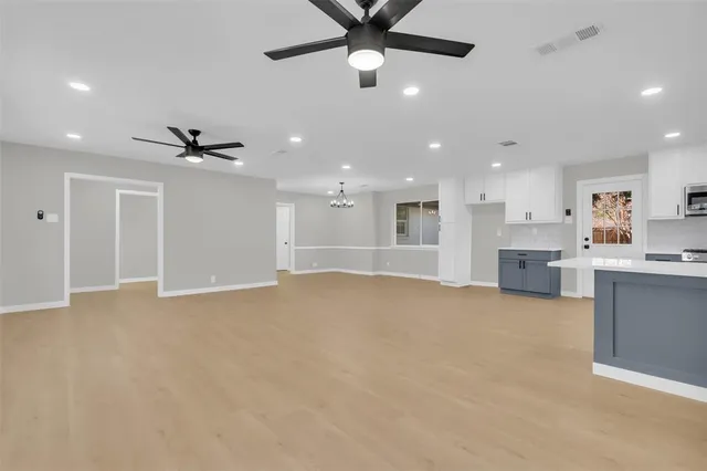 a view of a kitchen with a sink and a refrigerator