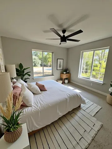 a bedroom with a large bed and a large window