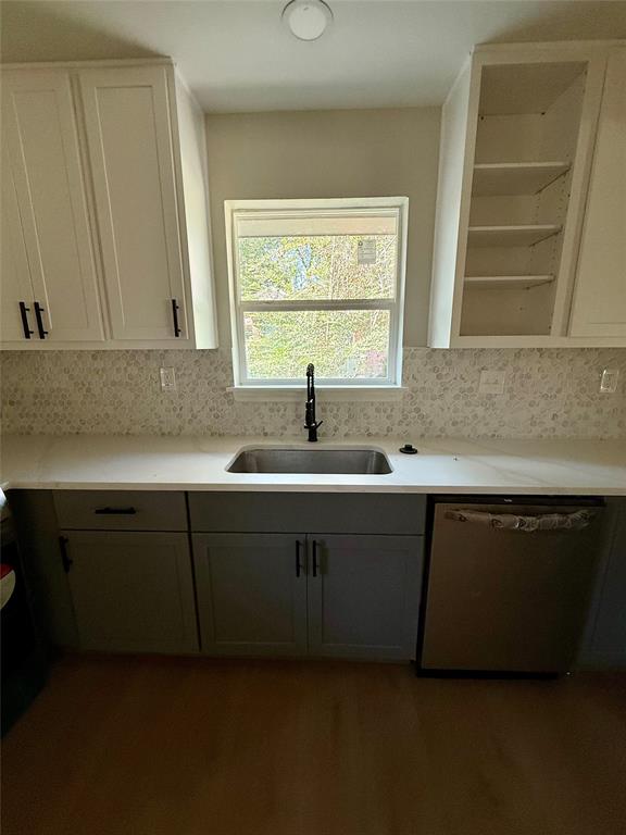 4815 Kelman Street Dallas, TX 75214 - Photo 6 of 16 Kitchen with dishwasher, light stone counters, dark wood-style floors, open shelves, and white cabinets