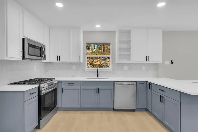 a kitchen with a sink stove and microwave