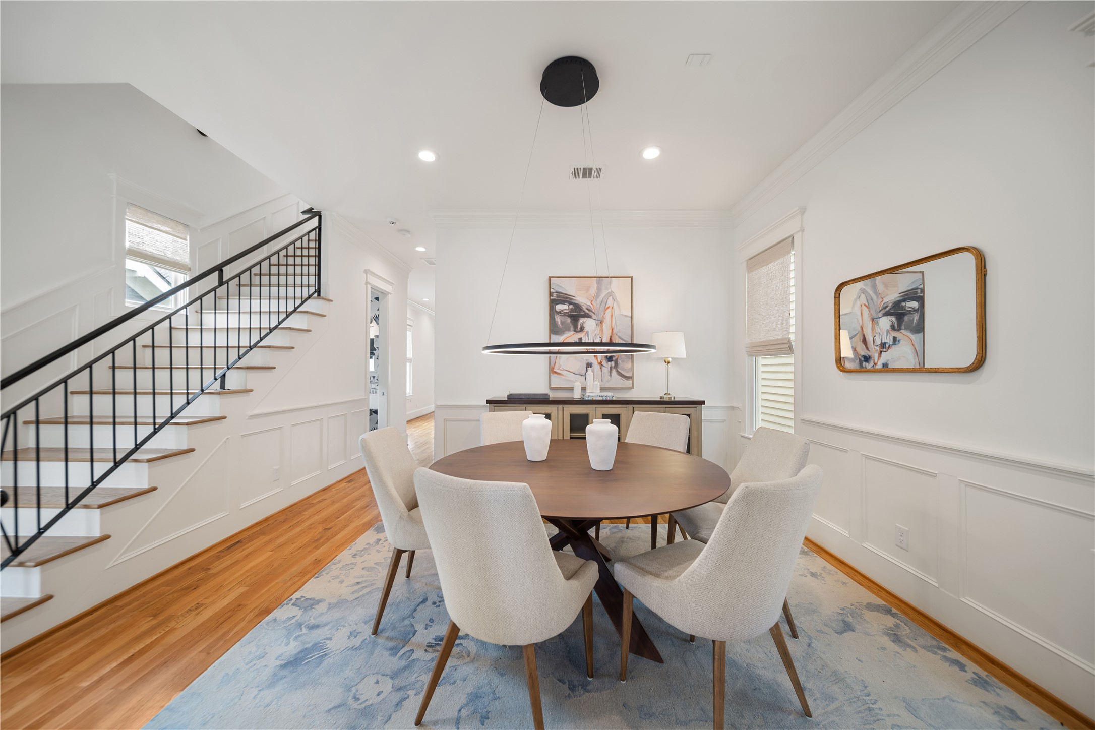 925 Tulane Street, Unit A Houston, TX 77008 - Photo 11 of 49 Plan your next dinner party in a formal dining room flanked by an updated wrought iron staircase.