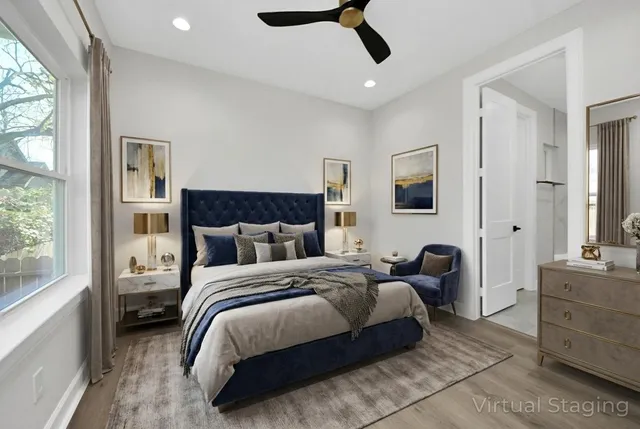 a bedroom with a large bed and a chandelier