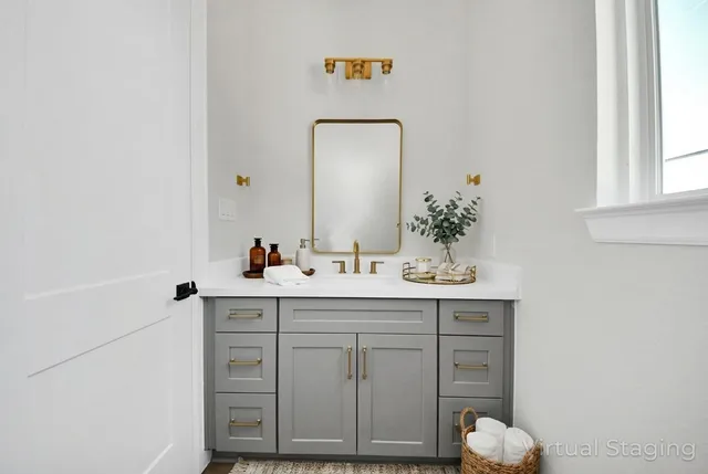 a bathroom with a sink vanity and mirror