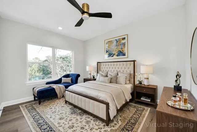 a spacious bathroom with a double vanity sink toilet mirror and bathtub