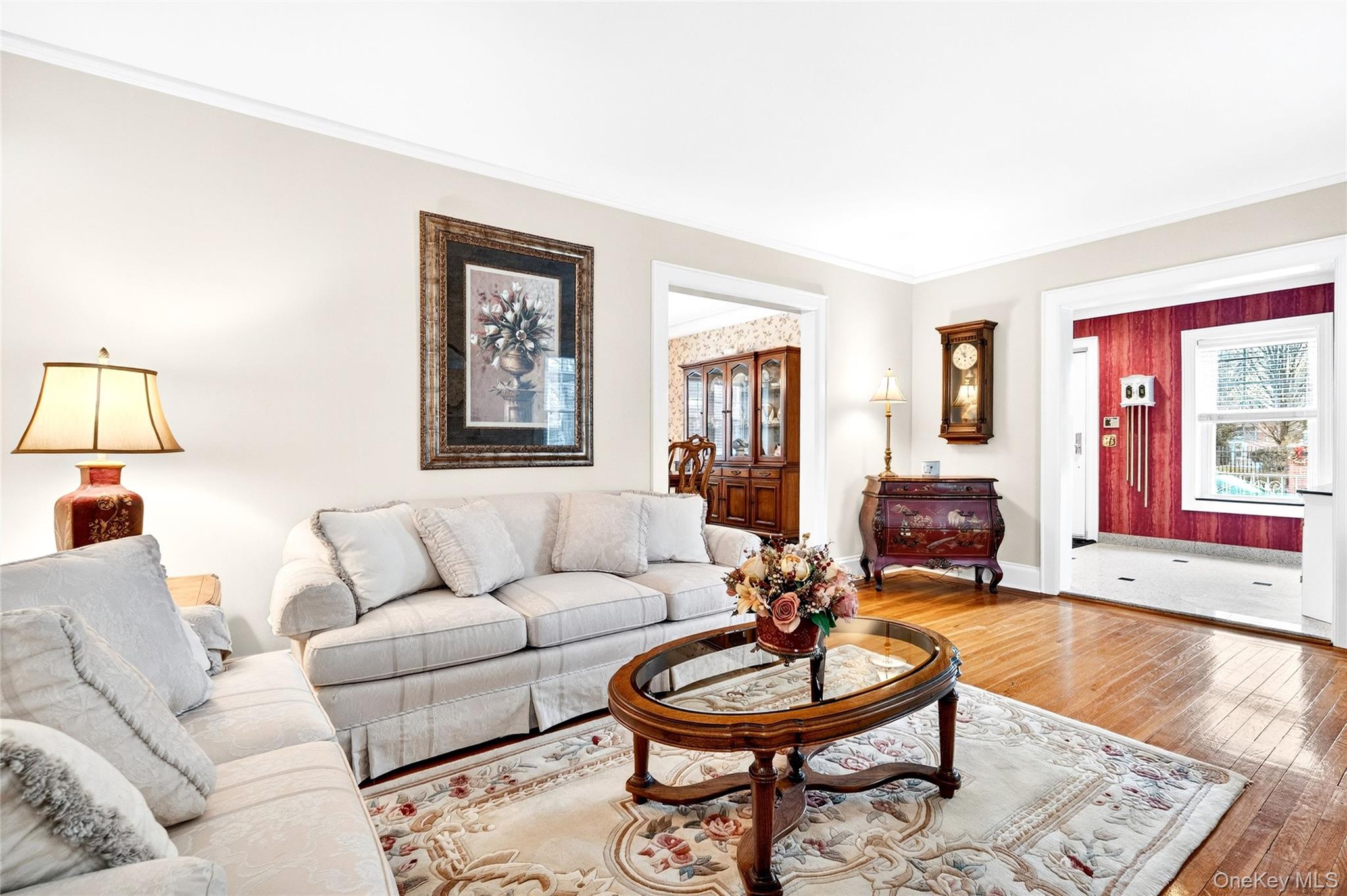 3334 Country Club Road Bronx, NY 10465 - Photo 9 of 49 Living room featuring hardwood / wood-style floors, plenty of natural light, and ornamental molding