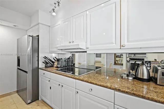 a kitchen with refrigerator and cabinets