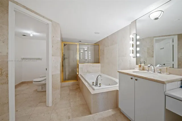 a bathroom with a tub sink and mirror
