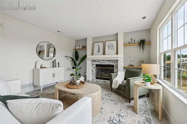 a living room with furniture and a fireplace