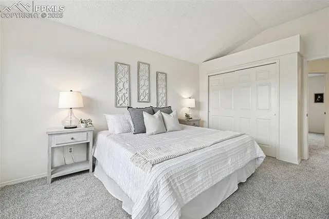 a bedroom with a bed and a lamp