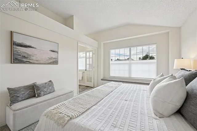 a bedroom with a large bed and a window