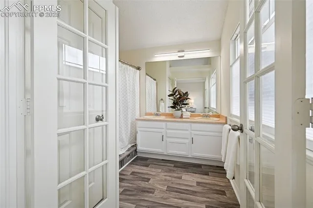 a bathroom with a sink mirror and