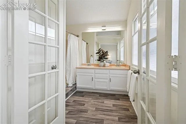 a bathroom with a sink vanity and mirror