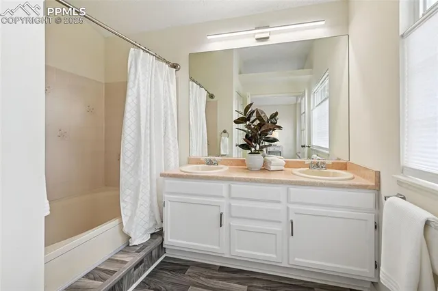 a bathroom with a double vanity sink and mirror
