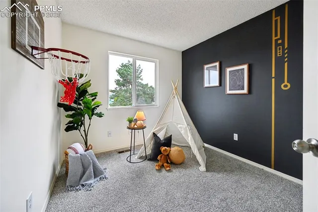 a living room with furniture and flowers