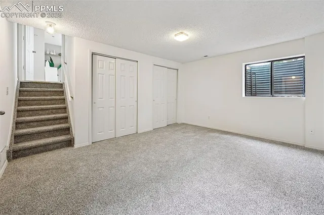 a view of an empty room with a fireplace