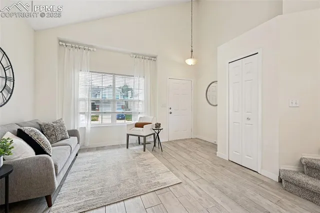 a living room with furniture a table and a window