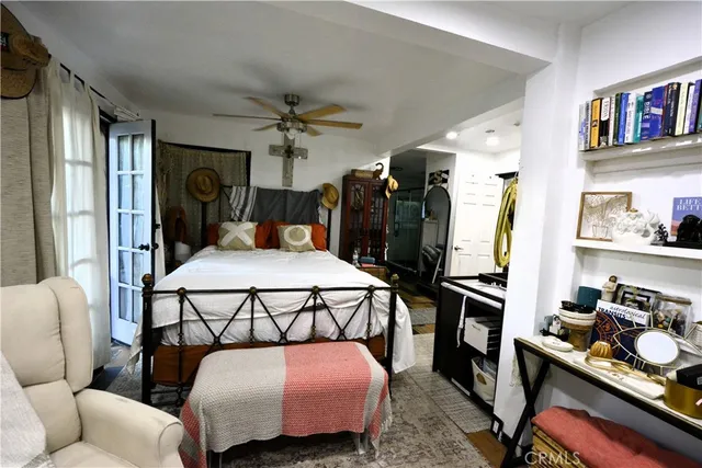 a bed sitting in a bedroom next to a window