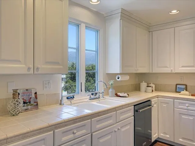 a kitchen with sink cabinets and wooden floor