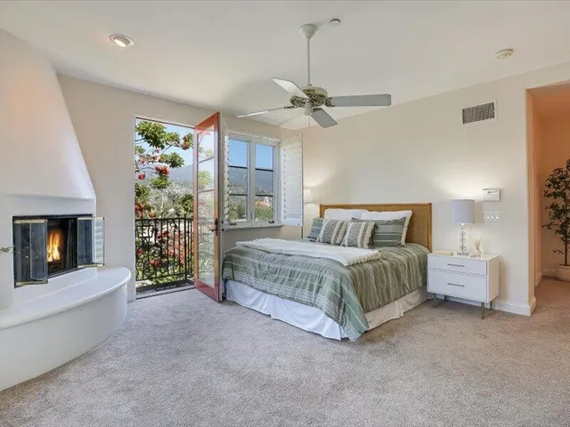 a bedroom with a bed and a fireplace