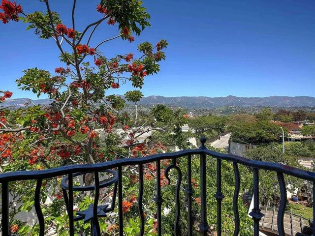 a view of a balcony with a flower garden