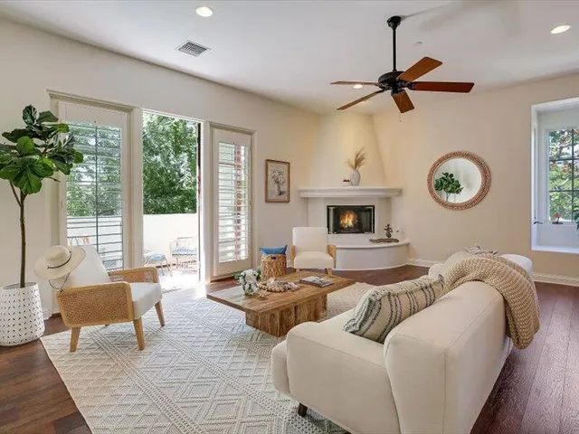 a living room with furniture a rug and a chandelier