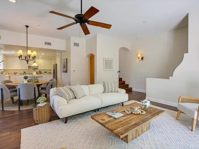 a dining room with furniture and a chandelier