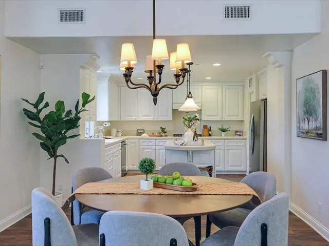a view of a dining room with furniture wooden floor and chandelier