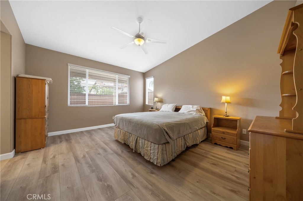 40889 Robards Way Murrieta, CA 92562 - Photo 17 of 36 a spacious bedroom with a bed and wooden floor