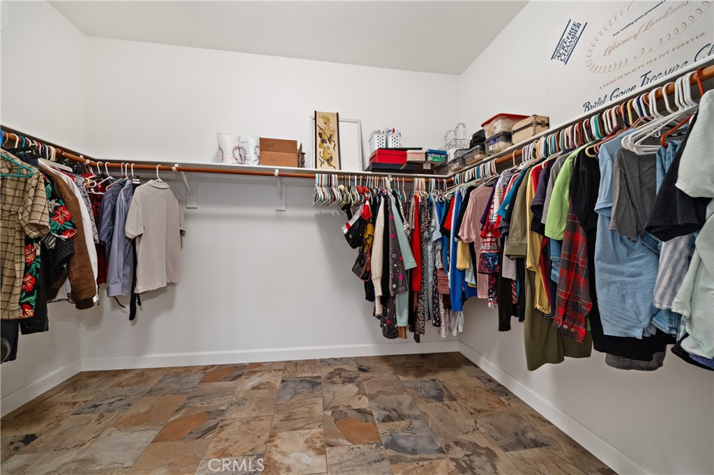 40889 Robards Way Murrieta, CA 92562 - Photo 21 of 36 a view of walk in closet with clothes and shoes