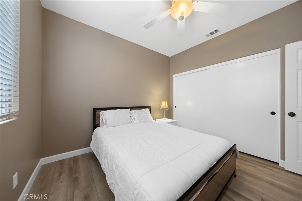 40889 Robards Way Murrieta, CA 92562 - Photo 23 of 36 a bedroom with a bed and a chandelier