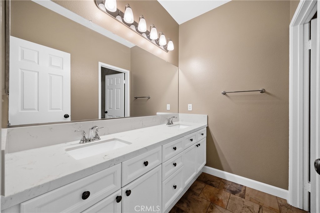 40889 Robards Way Murrieta, CA 92562 - Photo 24 of 36 a bathroom with a double vanity sink and a mirror