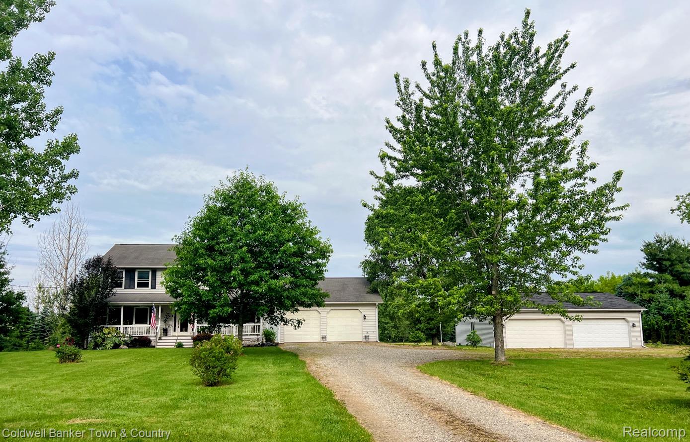 717 North Youngs Road Attica, MI 48412 - Photo 86 of 87 Spacious residence featuring a covered front porch, extensive green lawn, and a gravel driveway