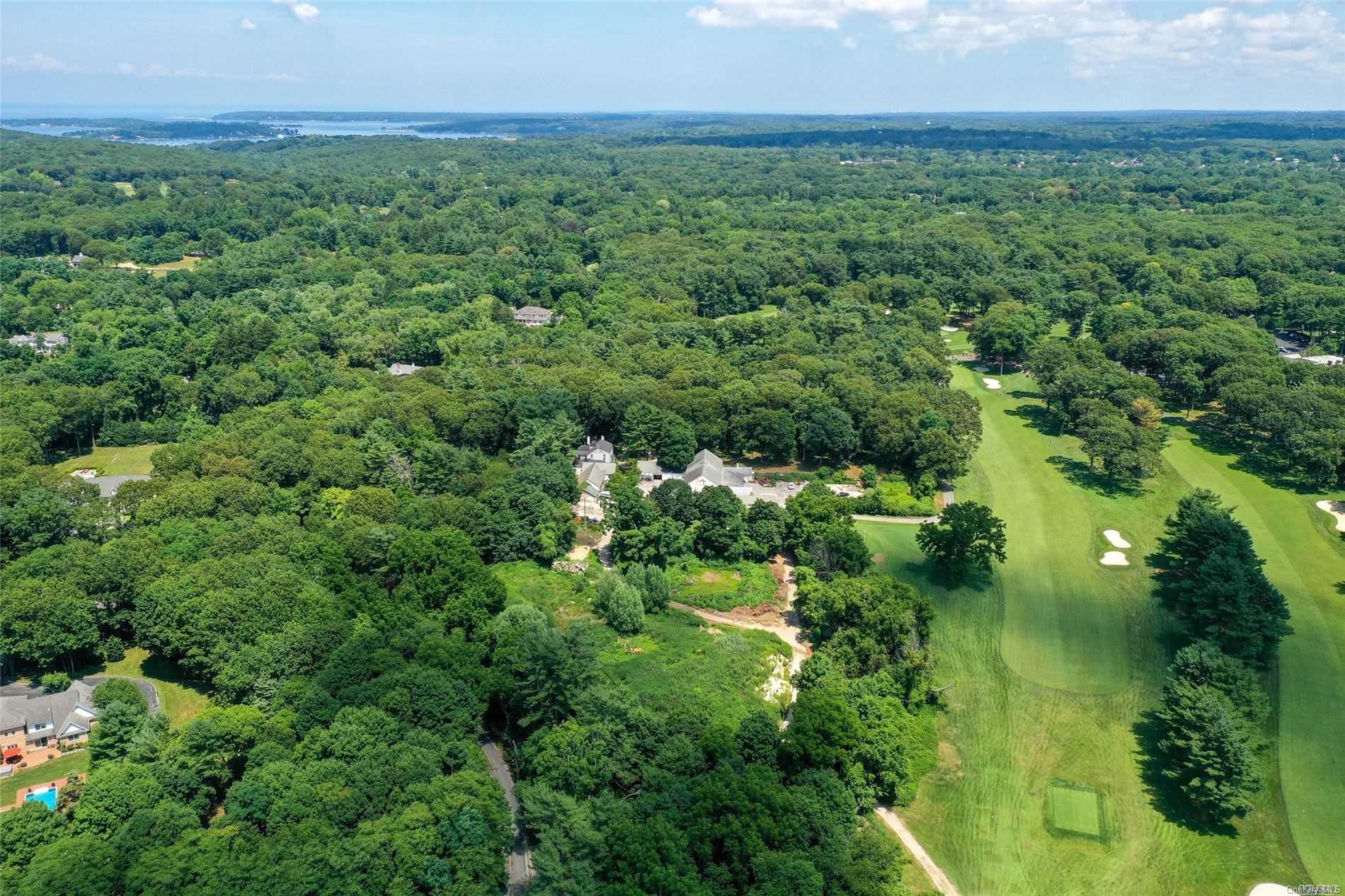 an aerial view of a houses with a yard