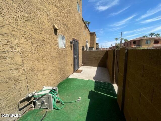 16225 North 30th Street, Unit 9 Phoenix, AZ 85032 - Photo 15 of 19 a view of backyard with wheel chair and potted plants