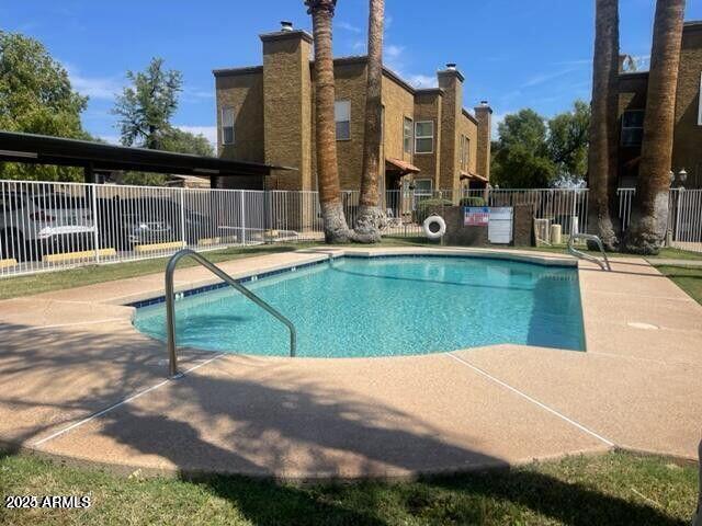 16225 North 30th Street, Unit 9 Phoenix, AZ 85032 - Photo 16 of 19 a view of a swimming pool with a lounge chairs