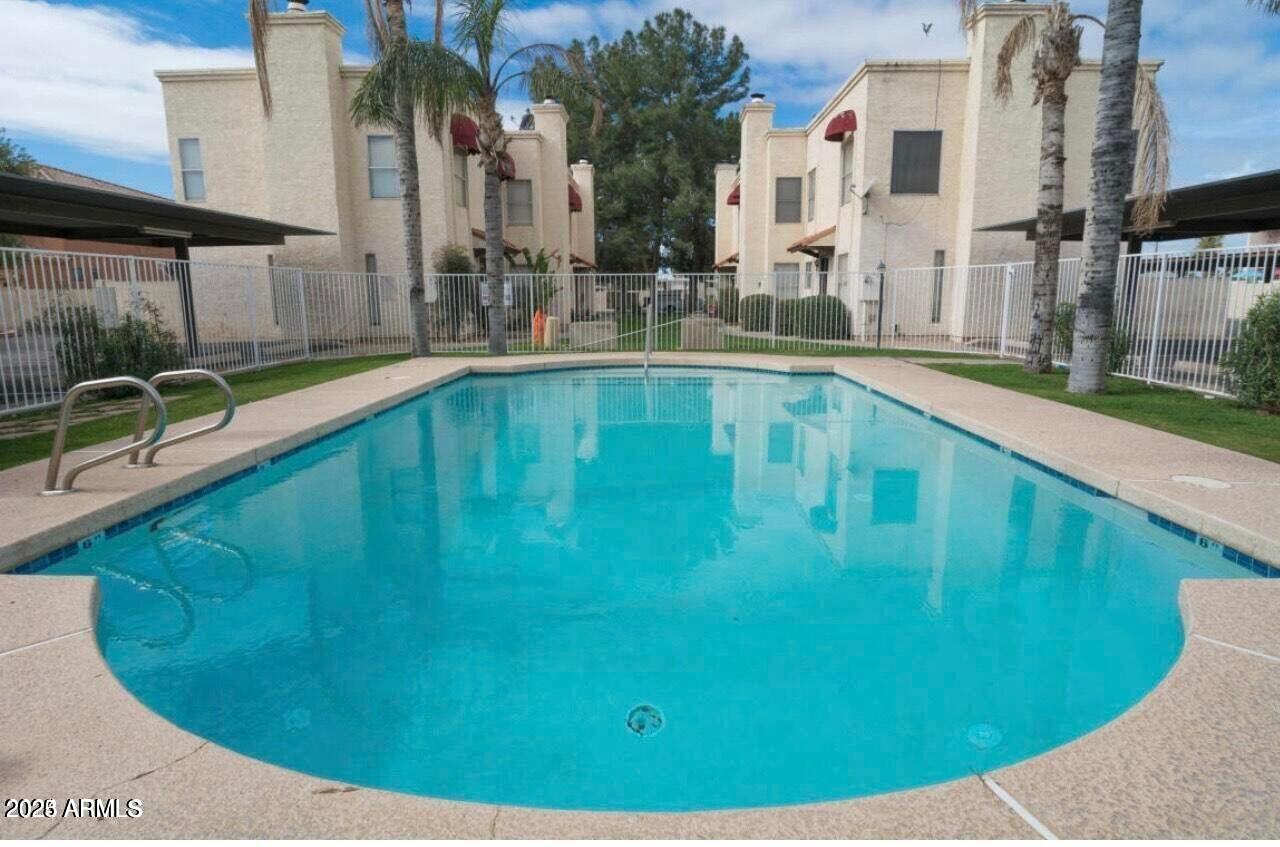16225 North 30th Street, Unit 9 Phoenix, AZ 85032 - Photo 18 of 19 a view of a swimming pool with a patio