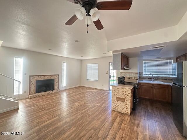 16225 North 30th Street, Unit 9 Phoenix, AZ 85032 - Photo 3 of 19 a kitchen with granite countertop a stove top oven a sink dishwasher a dining table and chairs with wooden floor